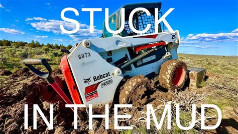 pull bobcat skid steer out of mud|bob cat skid steer stuck.